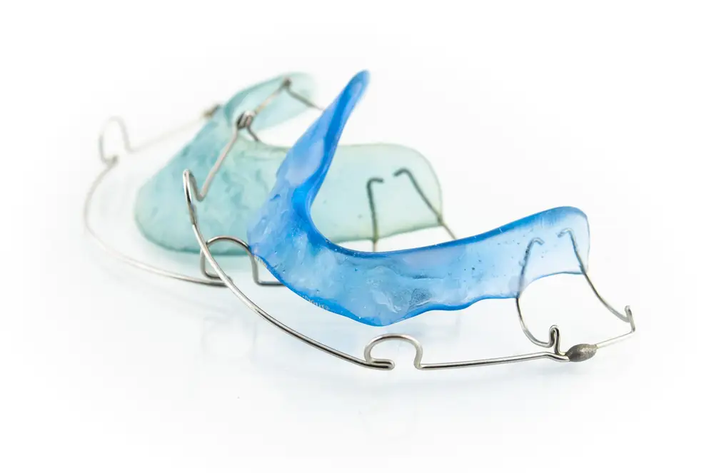 close up of blue dental braces isolated on white background