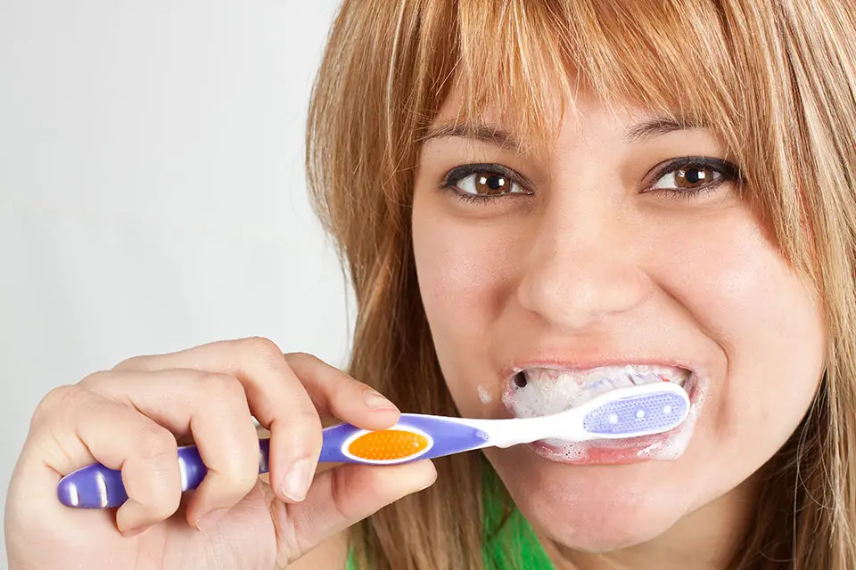 woman brushing teeth